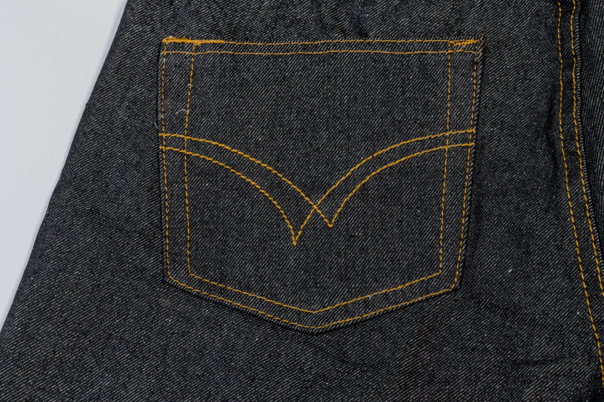 Back pocket with gold arcuate topstitching